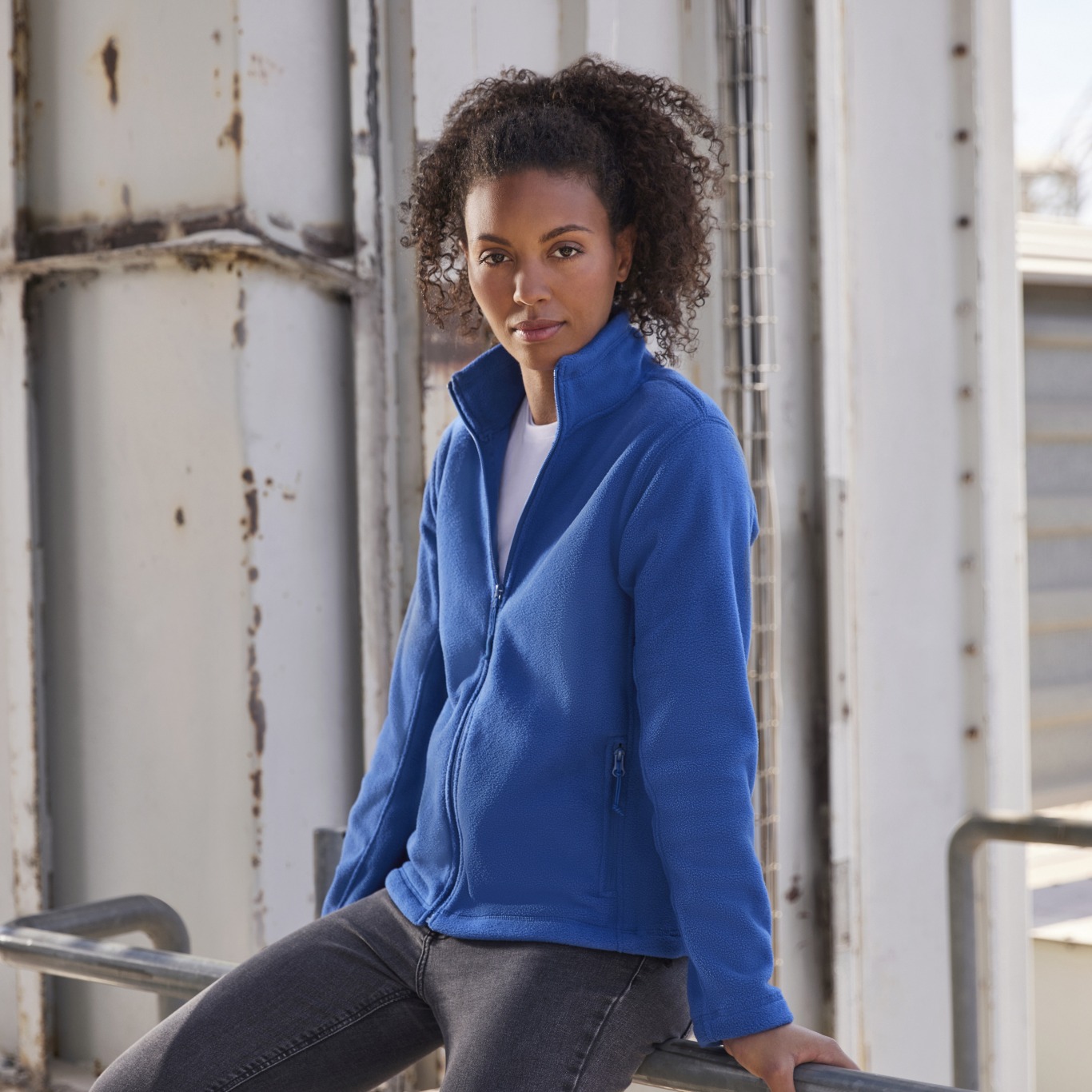 Woman styled in workwear fleece, tailored to the female body shape, ie. shorter torso. 