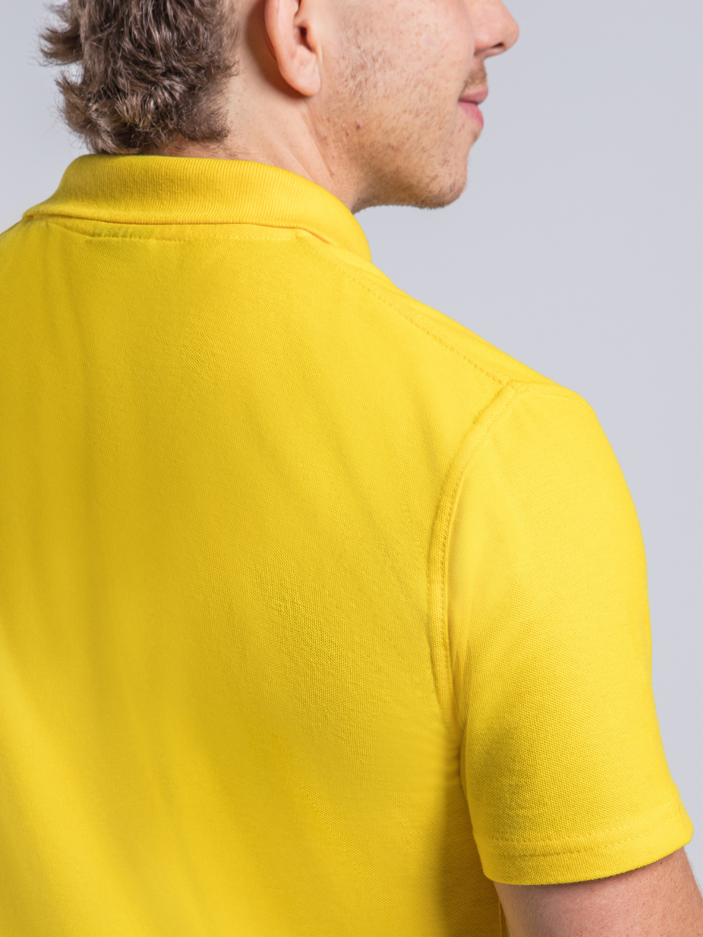 Yellow polo showing twin needle stitching