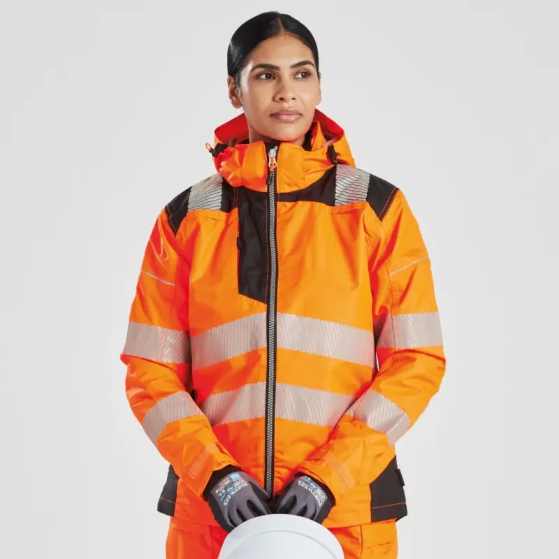 Woman wearing orange hi-vis jacket holding safety helmet 